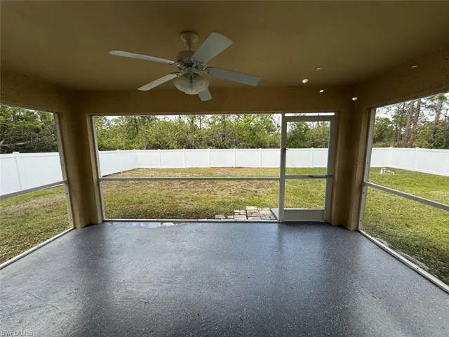 Unfurnished sunroom featuring ceiling fan