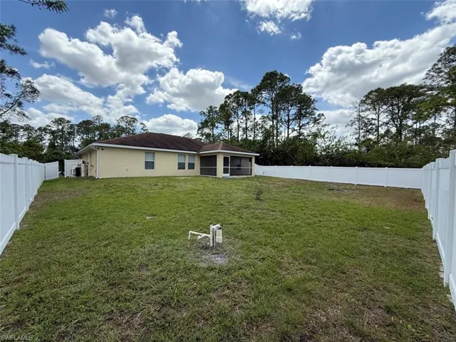 Rear view of house with stucco siding