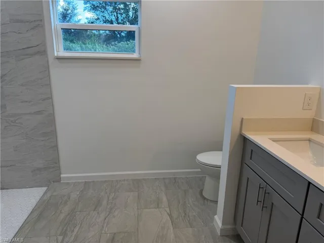 Full bathroom featuring vanity and toilet