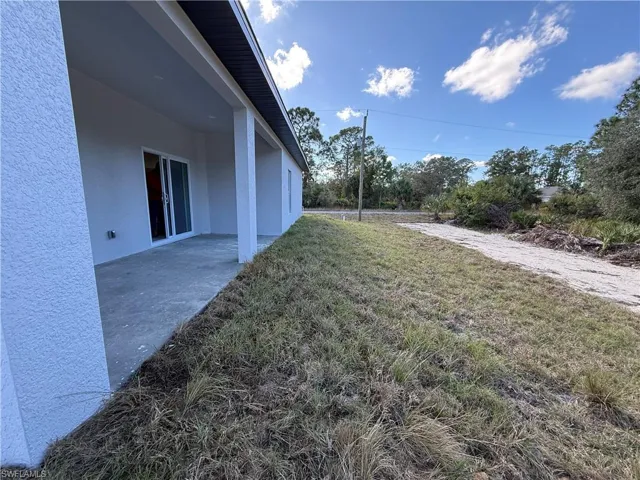 View of green lawn featuring a patio area