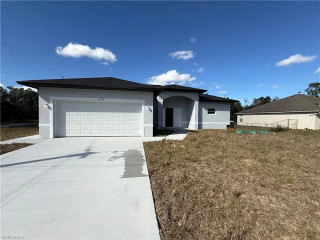 Single story home featuring stucco siding, concrete driveway, and an attached garage