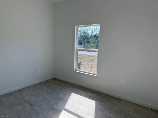 Spare room featuring baseboards