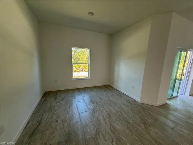Unfurnished room featuring baseboards
