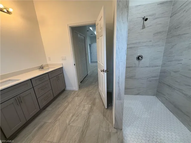 Bathroom with double vanity and walk in shower