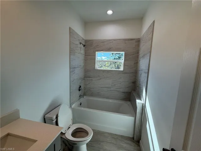 Bathroom featuring vanity and shower / bath combination