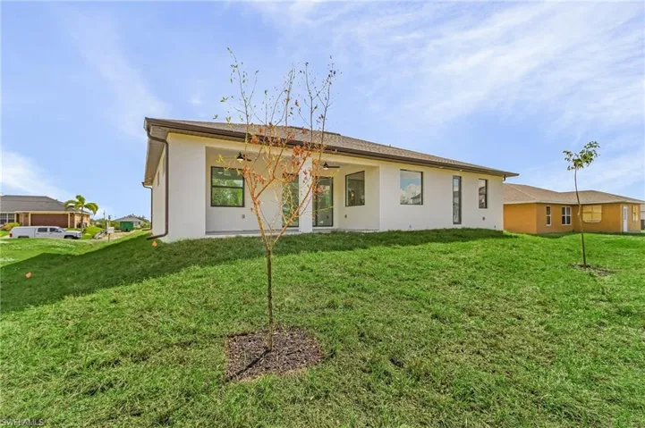 Back of property featuring a lawn