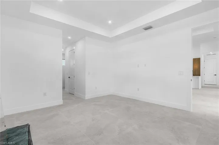 Unfurnished room featuring a raised ceiling