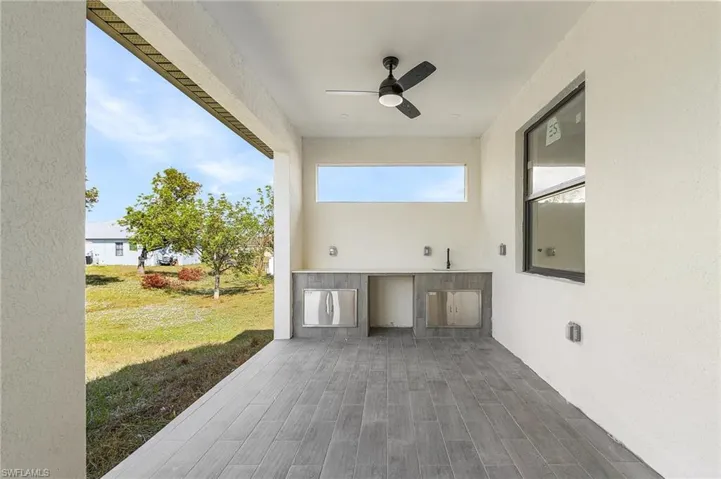 View of patio / terrace with ceiling fan, area for grilling, and sink