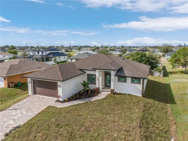 Ranch-style home with a front yard and a garage