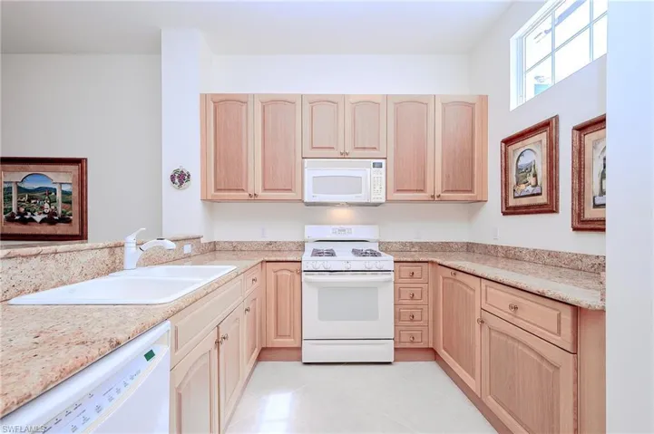 Long View of the Kitchen with coordinated granite counters, tile and appliances