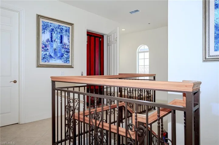 Upstairs landing by elevator.  Front bedroom and balcony to the Left
