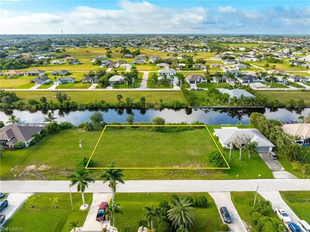 Birds eye view of property with a water view