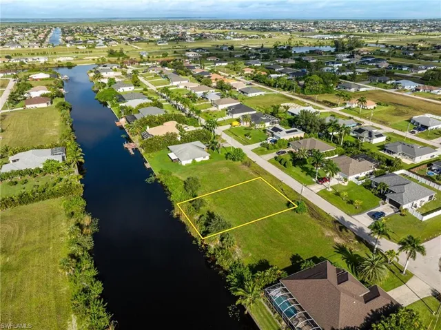 Birds eye view of property with a water view