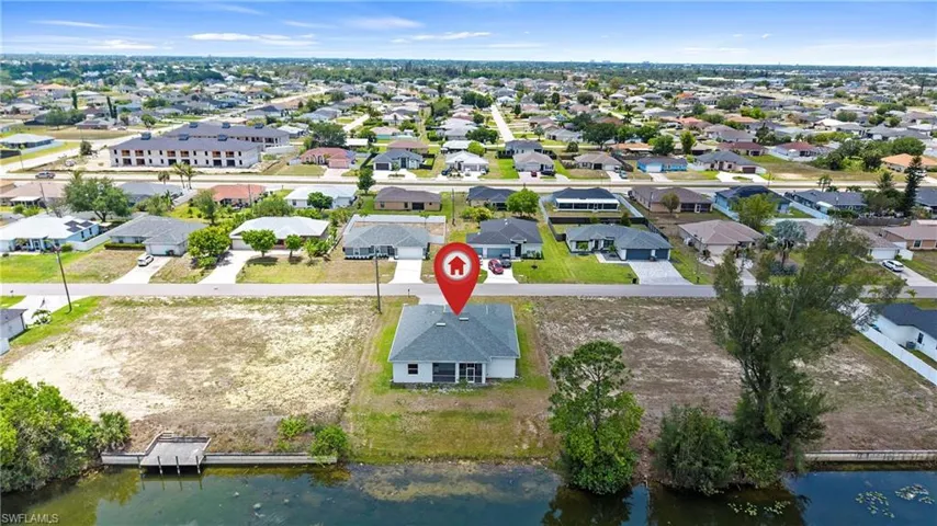 Waterfront lot featuring a developed seawall and a wooden dock