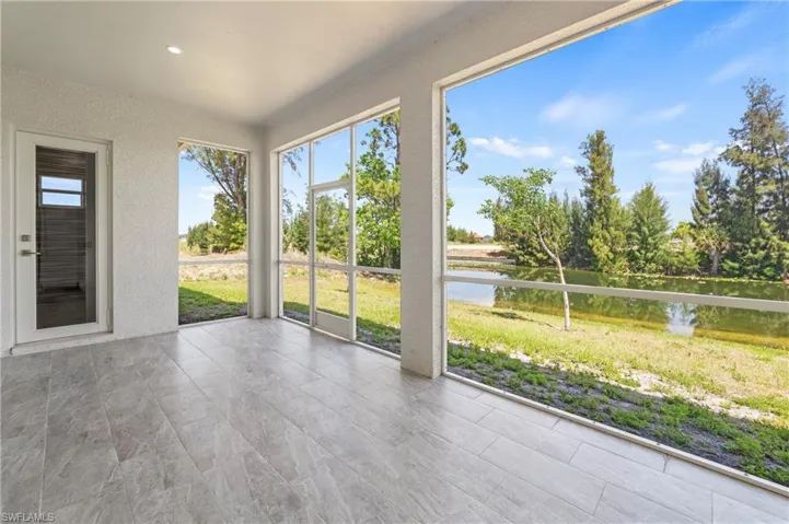Screened lanai featuring large format tile flooring and a water-facing orientation