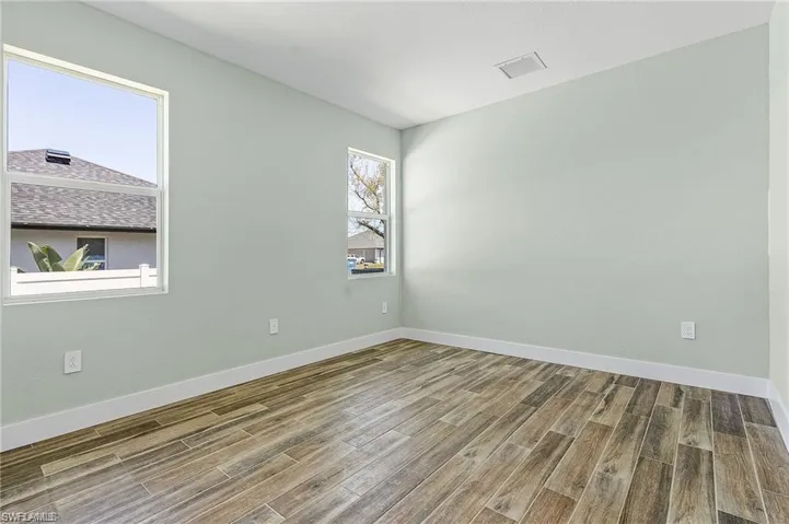 Empty room featuring wood-type flooring
