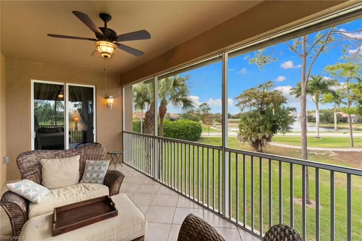 Sunroom / solarium featuring ceiling fan, a balcony, and a water view