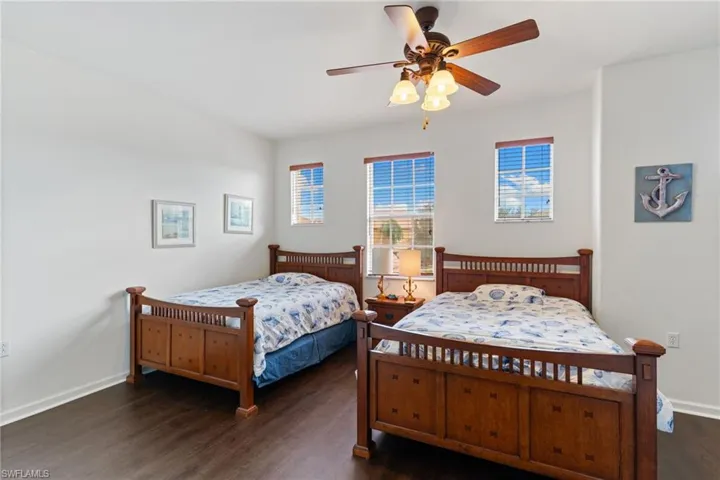 Bedroom with dark wood flooring and ceiling fan