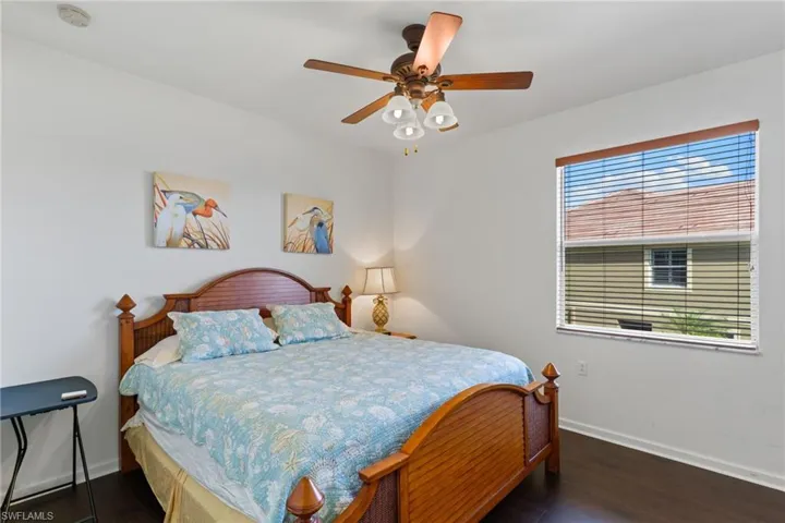 Bedroom featuring a ceiling fan and dark wood-type flooring