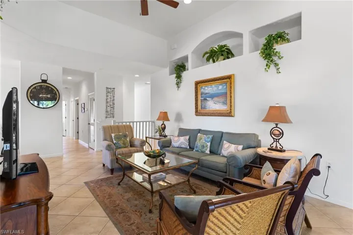 Living area with light tile patterned flooring, recessed lighting, and a ceiling fan