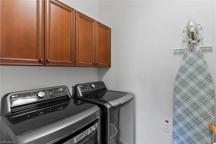 Laundry room cabinet space and washer and clothes dryer