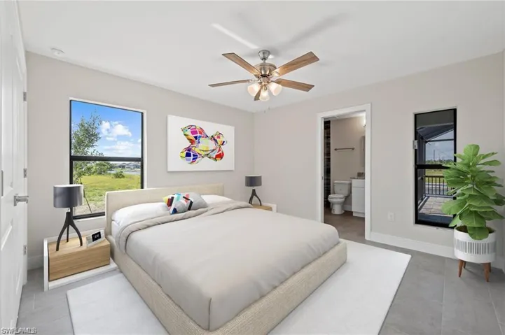 Bedroom with ensuite bathroom, tile patterned floors, and a ceiling fan