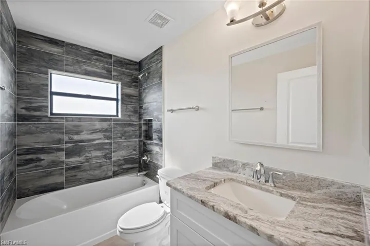 Full bath featuring vanity and  shower combination
