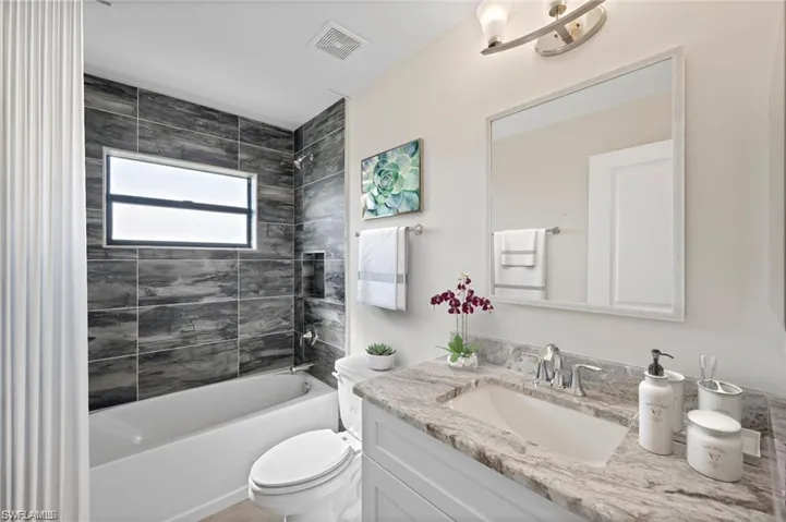 Bathroom featuring vanity and shower / bath combination