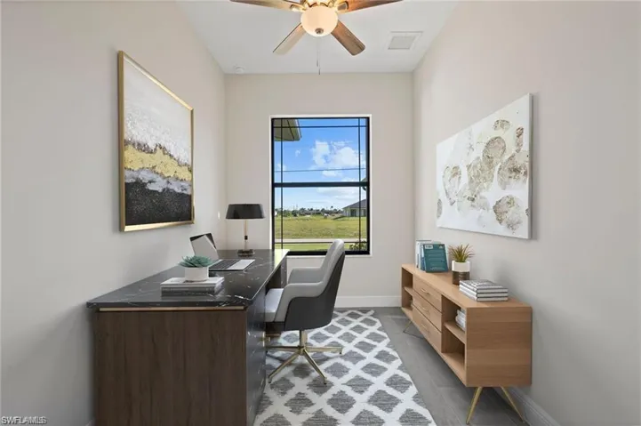 Home office featuring baseboards and ceiling fan