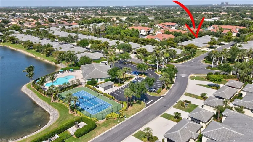 Drone / aerial view with a residential view and a water view
