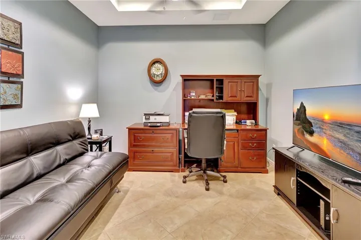 Office space with light tile patterned floors and a ceiling fan