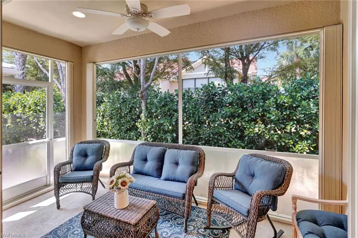 Sunroom with an outdoor living space and a ceiling fan
