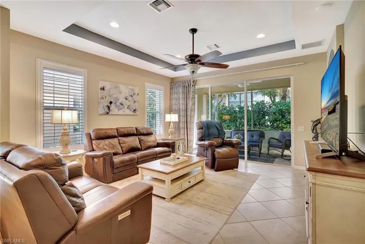 Living room with visible vents and a raised ceiling