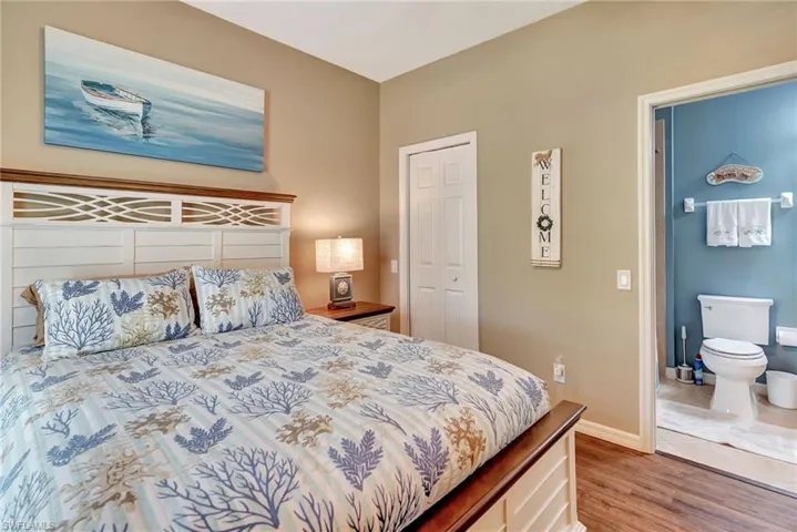 Bedroom with a closet, baseboards, and wood finished floors
