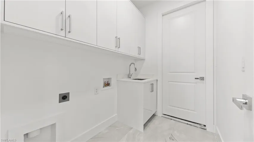 Laundry area with cabinet space, hookup for an electric dryer, and hookup for a washing machine