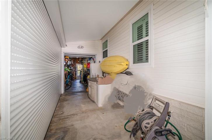 Covered side porch area into the shed Each has its own garage door which can be shut
