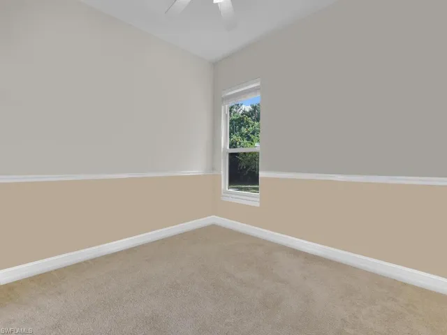 Spare room with carpet flooring and ceiling fan