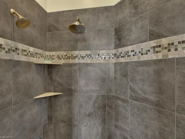 Room details featuring a tile shower