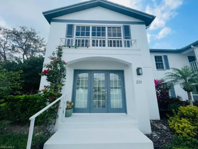 Doorway to property featuring french doors and stucco siding