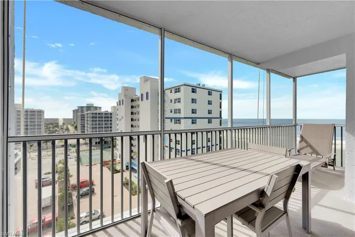 Sunroom / balcony with a view of the Gulf and beach. New screen and flooring on balcony.