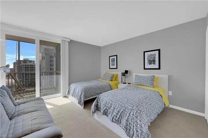 Carpeted bedroom featuring floor to ceiling windows and access to outside