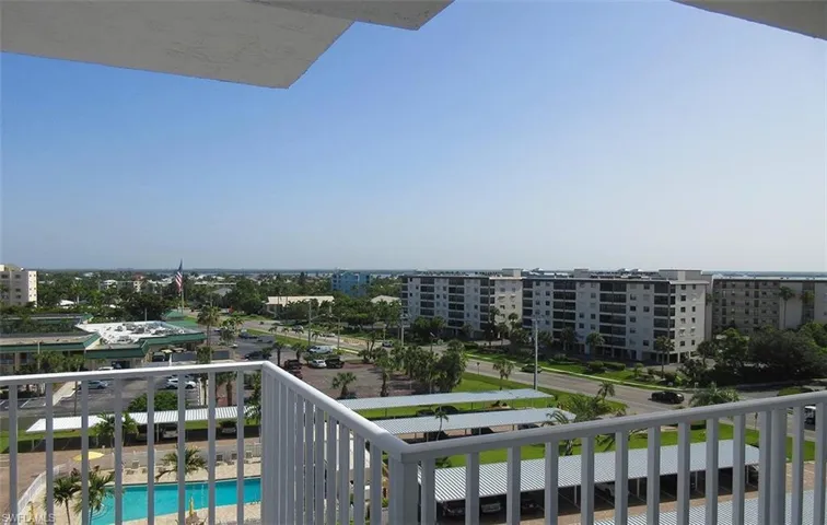 Balcony featuring view of pool area and Estero Bay
