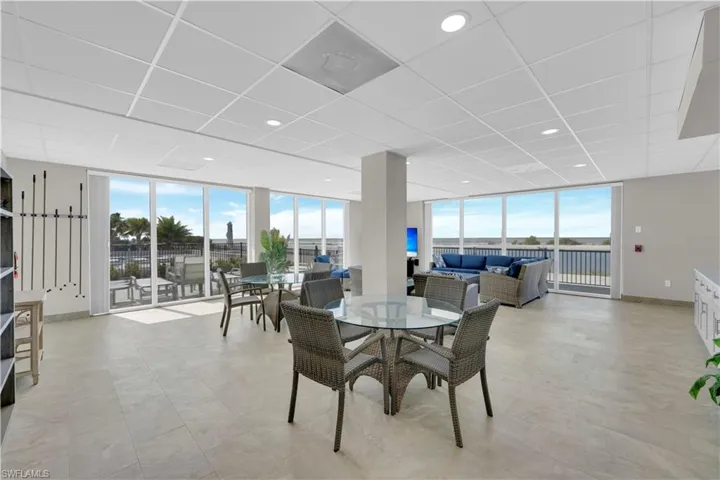 Dining space featuring floor to ceiling windows and a paneled ceiling