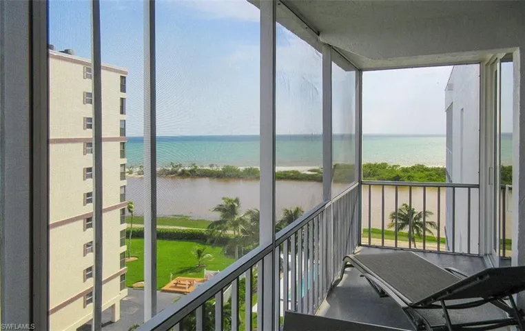 Sunroom/balcony with a beach view