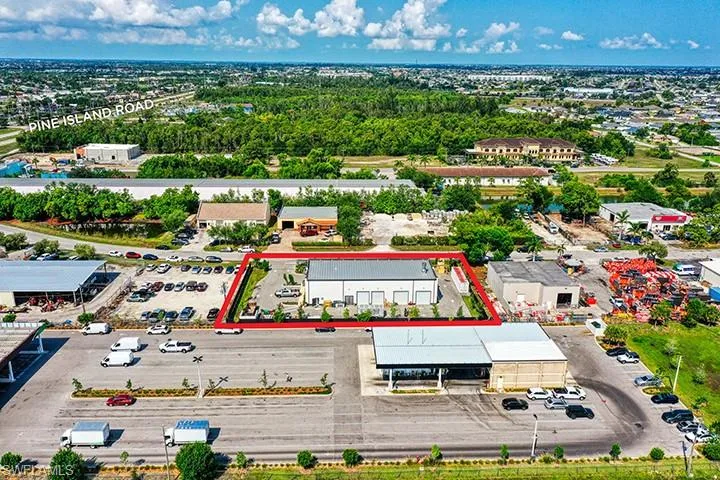 Aerial view of property and surrounding area with property parcel outlined