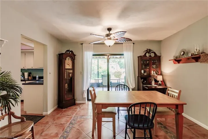 Tiled dining room featuring ceiling fan