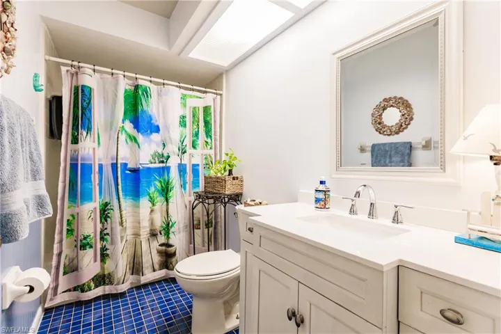 Bathroom featuring vanity, toilet, and tile patterned flooring