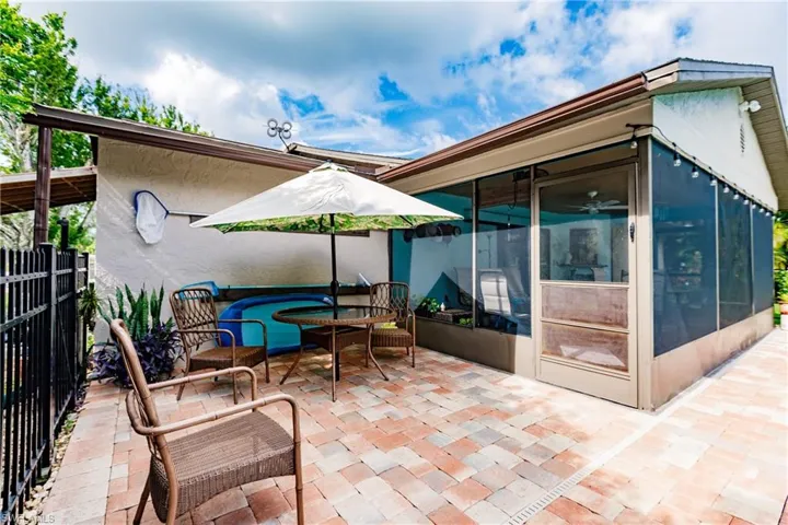 View of patio with a sunroom