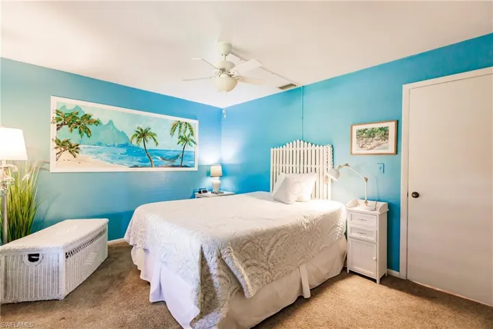 Carpeted bedroom featuring ceiling fan