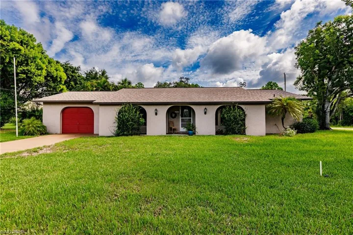Ranch-style house with a garage and a front yard